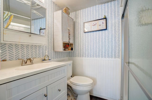 bathroom with a shower, vanity, and toilet