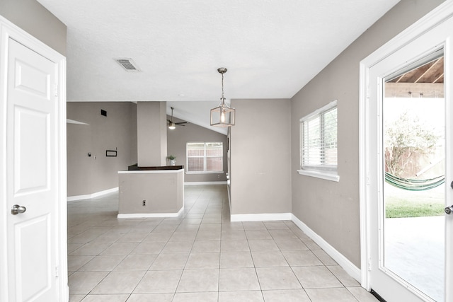 interior space with light tile patterned floors and ceiling fan