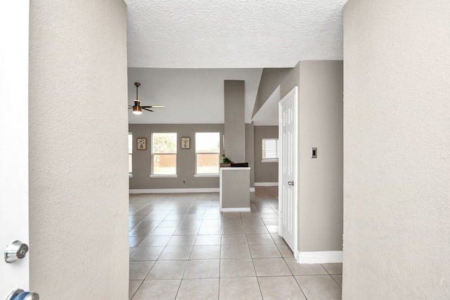 interior space with a textured ceiling and ceiling fan