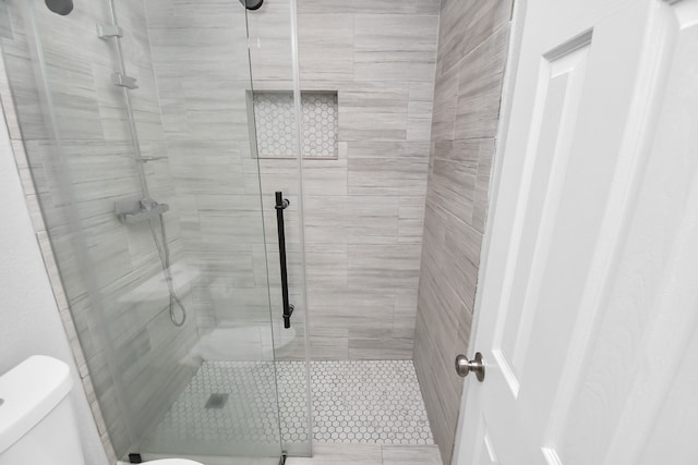 bathroom with toilet and walk in shower