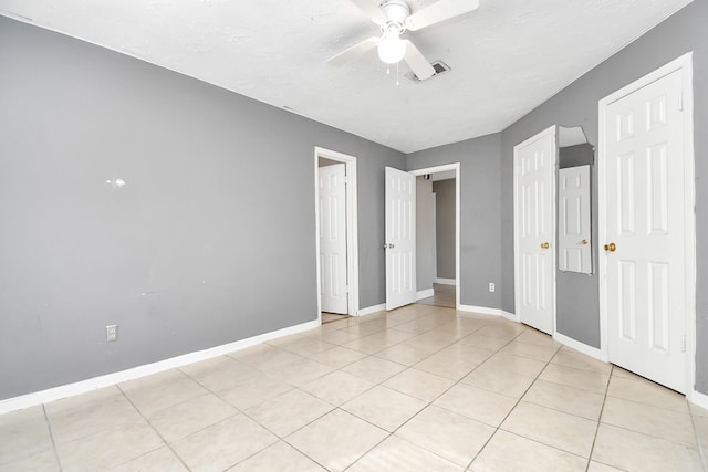 unfurnished bedroom featuring ceiling fan and light tile patterned floors