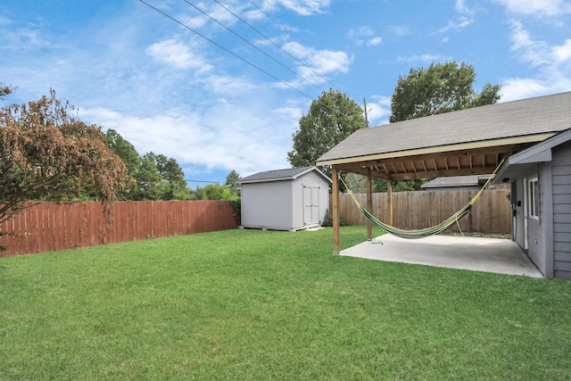 view of yard with a storage shed and a patio area