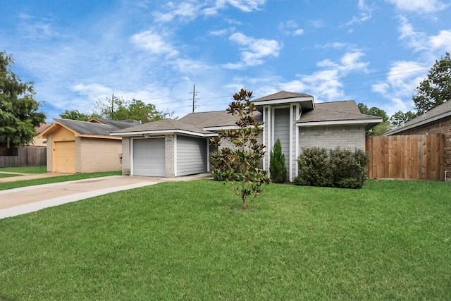 single story home featuring a garage and a front lawn