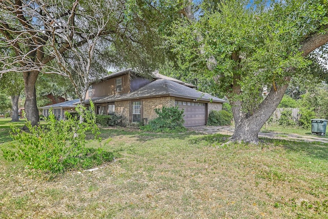 view of front facade with a garage, brick siding, and a front lawn