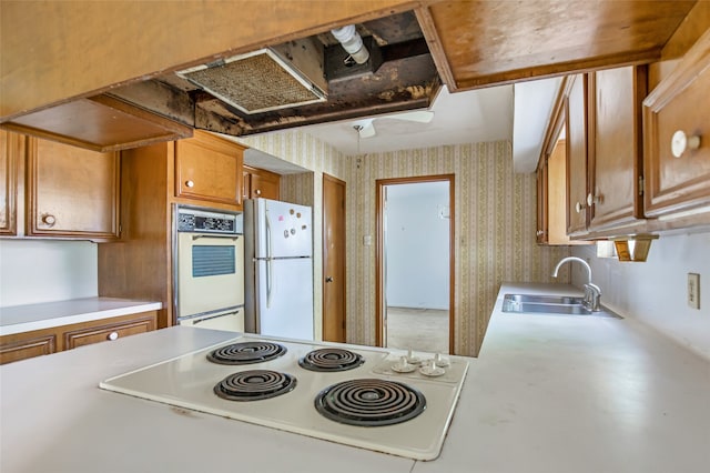 kitchen featuring white appliances and sink