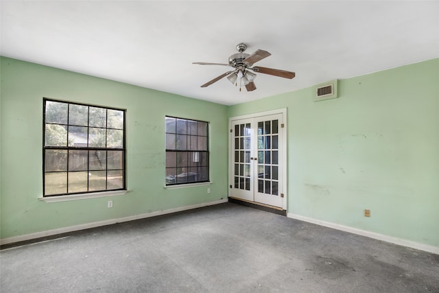 unfurnished room with concrete floors, ceiling fan, and french doors