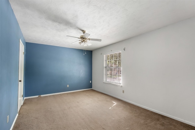 unfurnished room with a textured ceiling, carpet, and ceiling fan