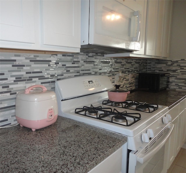 kitchen featuring white cabinets, white appliances, light stone counters, and tasteful backsplash