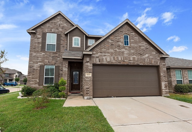 view of front property featuring a garage and a front yard