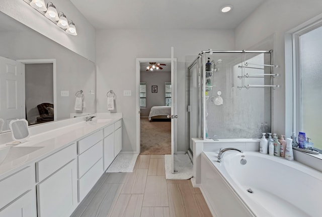 bathroom with separate shower and tub, ceiling fan, and vanity