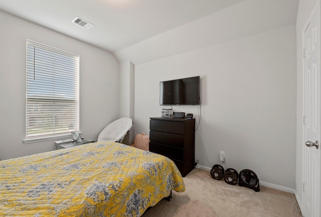 carpeted bedroom with vaulted ceiling