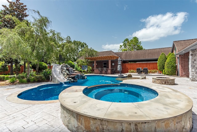 view of swimming pool with a patio and an in ground hot tub