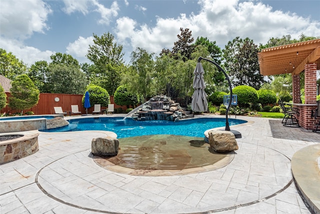 view of swimming pool with a patio area, an in ground hot tub, and pool water feature