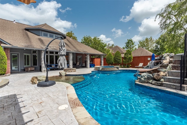 view of swimming pool featuring french doors, a storage shed, a patio, and an in ground hot tub