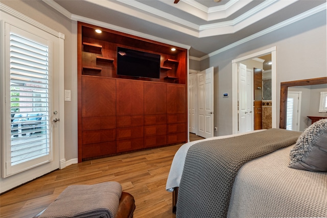 bedroom with hardwood / wood-style floors, multiple windows, and crown molding