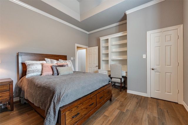 bedroom featuring crown molding and wood-type flooring