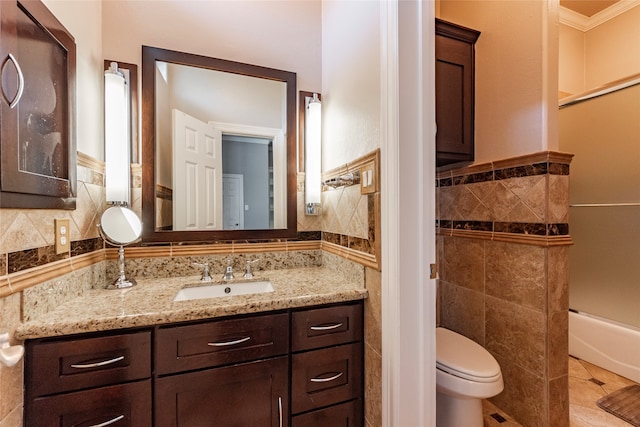 bathroom with toilet, tile walls, vanity, tasteful backsplash, and ornamental molding