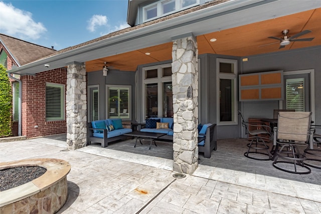 view of patio / terrace with an outdoor living space with a fire pit and ceiling fan