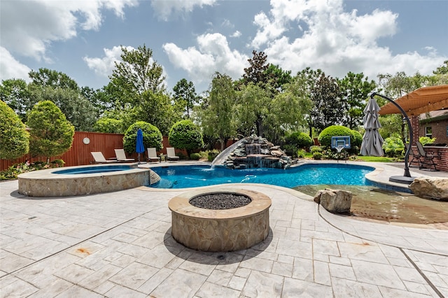 view of swimming pool featuring an outdoor fire pit, a patio, an in ground hot tub, and pool water feature