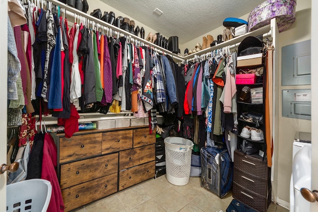 spacious closet featuring tile patterned flooring and washer / clothes dryer