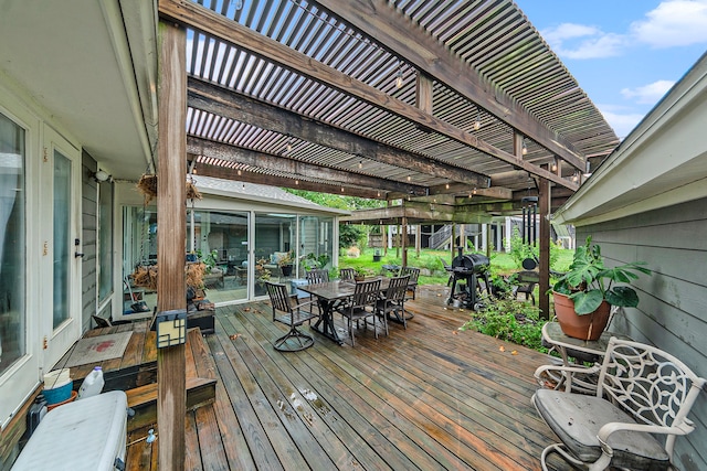 wooden deck featuring a grill, outdoor dining area, and a pergola