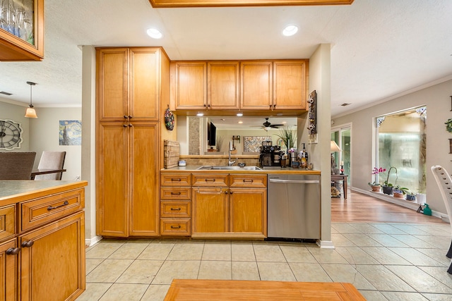 kitchen with dishwasher, light tile patterned floors, a sink, and crown molding