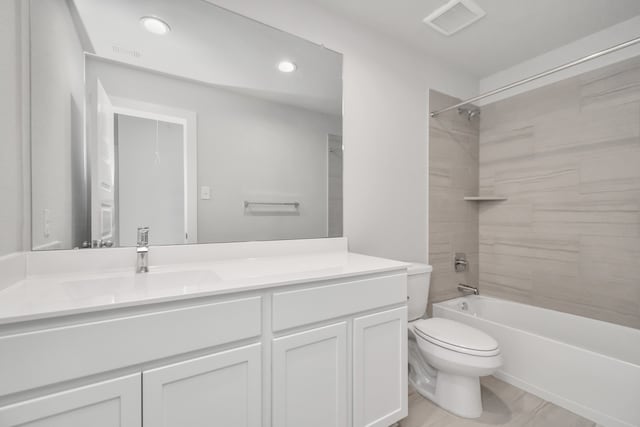 full bathroom featuring toilet, tiled shower / bath combo, and vanity