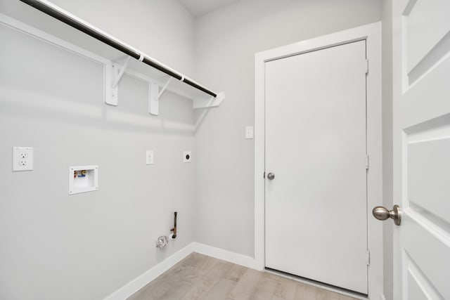 clothes washing area featuring electric dryer hookup, hookup for a washing machine, light wood-type flooring, and hookup for a gas dryer