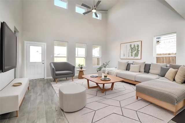 living room featuring a high ceiling and ceiling fan