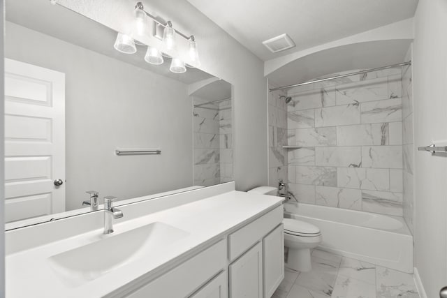 full bathroom featuring vanity, tiled shower / bath combo, and toilet