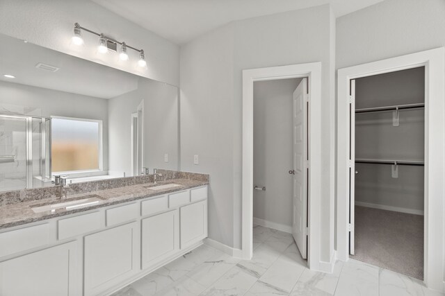 bathroom with an enclosed shower and vanity