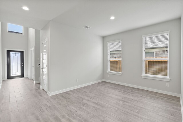 spare room with light hardwood / wood-style flooring