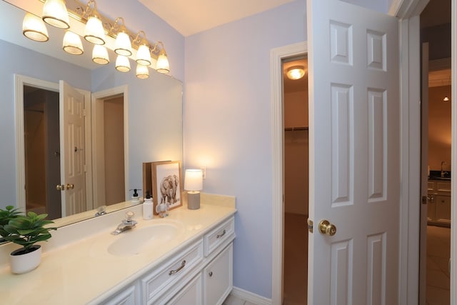 bathroom with vanity and a closet