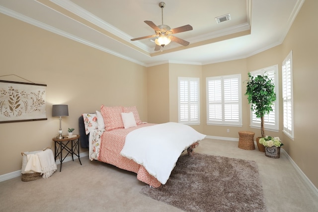 bedroom featuring visible vents, carpet flooring, crown molding, and a tray ceiling