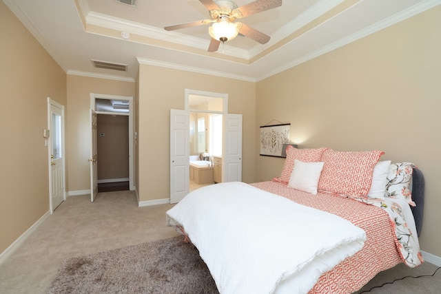bedroom with light colored carpet, a tray ceiling, visible vents, and ornamental molding