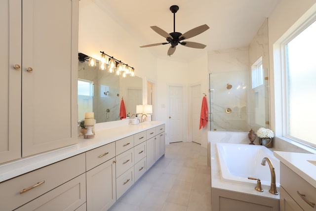 full bath with plenty of natural light, a ceiling fan, vanity, and a shower stall