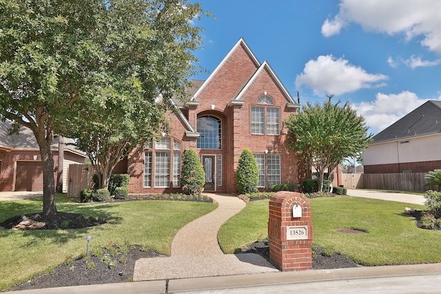 view of property featuring a front lawn and a garage