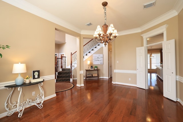 dining space featuring visible vents, wood finished floors, stairway, and an inviting chandelier