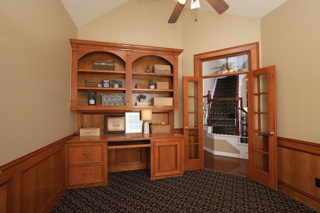 office with wainscoting, a ceiling fan, built in desk, and lofted ceiling