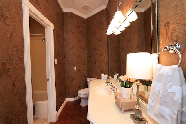 full bathroom with visible vents, crown molding, wood finished floors, baseboards, and toilet