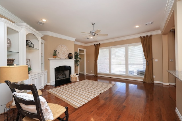 living room with a ceiling fan, visible vents, dark wood-type flooring, and a fireplace
