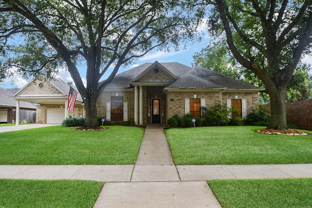 view of front of property featuring a garage and a front lawn