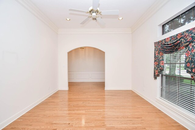 spare room with light wood-type flooring, ceiling fan, and ornamental molding