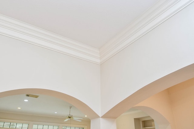 interior details featuring crown molding and ceiling fan