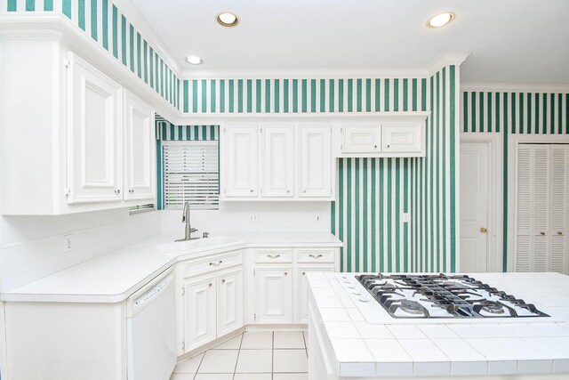 kitchen featuring gas cooktop, dishwasher, tile counters, and sink