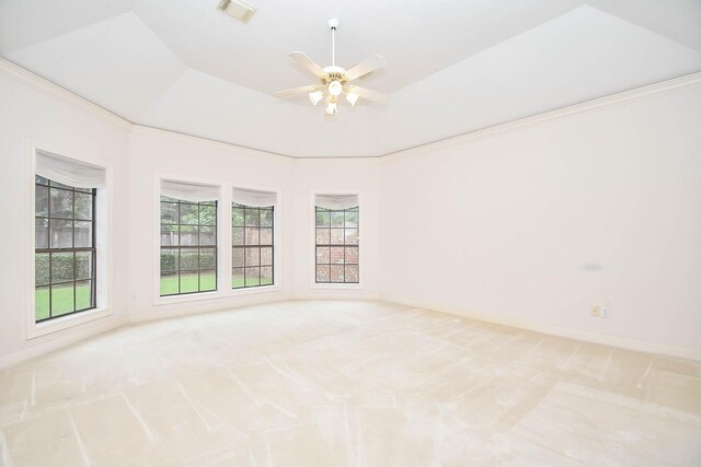 empty room featuring ceiling fan, light colored carpet, and plenty of natural light