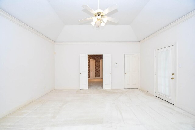 empty room with ceiling fan, crown molding, light carpet, and vaulted ceiling