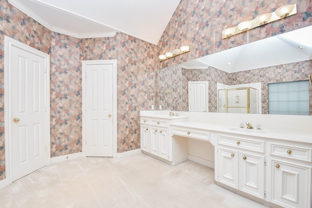 bathroom featuring crown molding, vanity, and vaulted ceiling