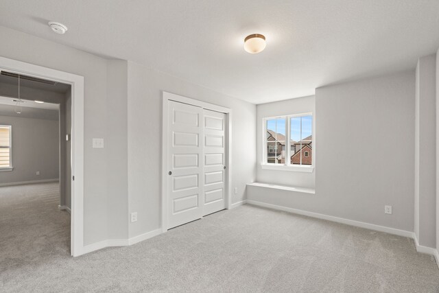 8427 Northern Pintail Dr, Houston, TX 77049 - unfurnished bedroom featuring carpet, a closet, and baseboards