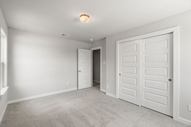 8427 Northern Pintail Dr, Houston, TX 77049 - unfurnished bedroom with carpet floors, a closet, baseboards, and visible vents